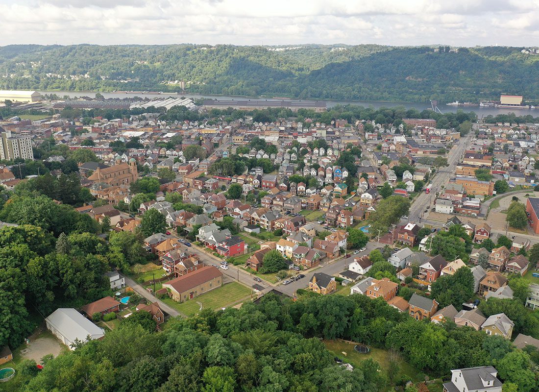 Lancaster, OH - Aerial View of a Town in Ohio With Homes and Trees and a River in the Background